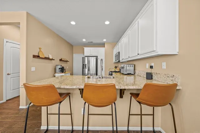 a view of kitchen with cabinets and dining table