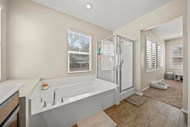a bathroom with a tub a sink and a shower