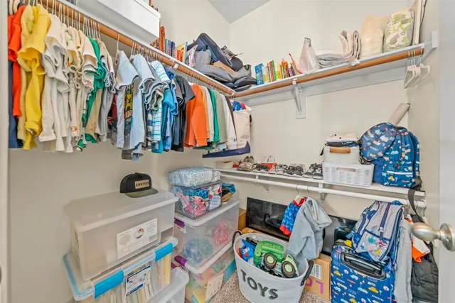 a utility room with stainless steel appliances a stove a chimney and a center island