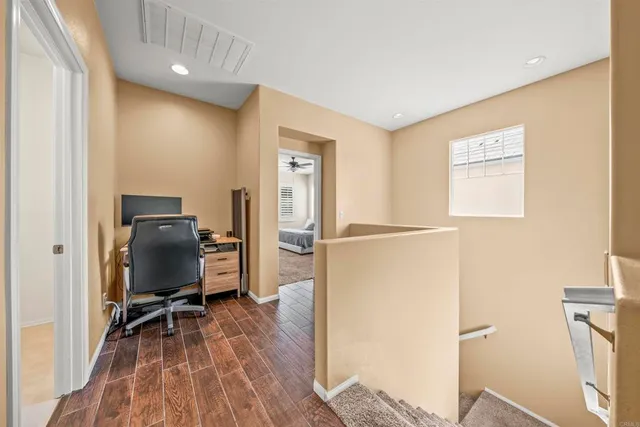 a view of a workspace with furniture and wooden floor