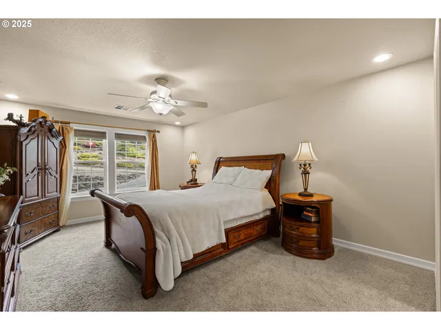 a bathroom with a granite countertop sink mirror and a bath tub