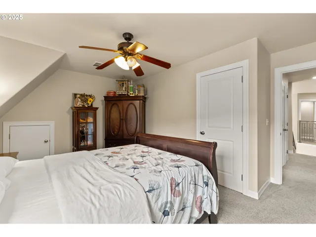 a bedroom with a bed a chandelier and a window