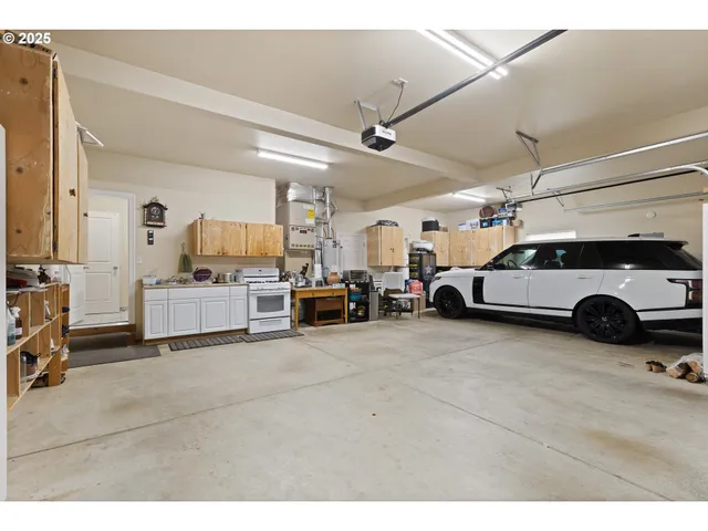 a kitchen with kitchen island a stove a sink and a refrigerator