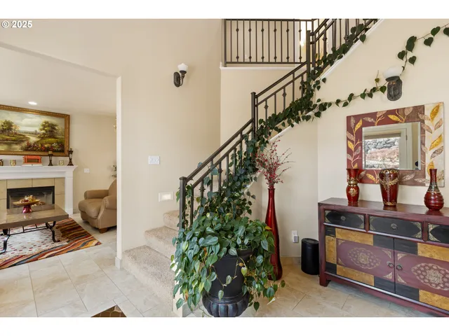 a living room with furniture a large window and a fireplace