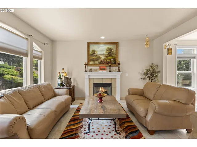 a living room with furniture a rug and a chandelier