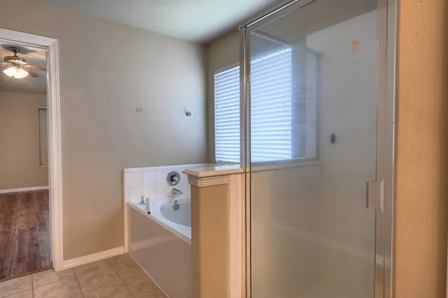 a bathroom with a bathtub and shower