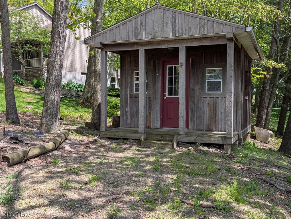 11154 Johnsford Road Southwest Beach City, OH 44608 - Photo 9 of 50 Rustic outbuilding featuring vertical wood siding and a covered porch