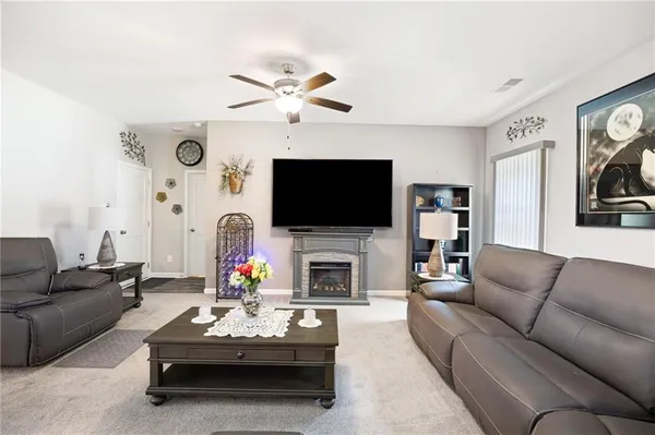 a living room with fireplace furniture and a flat screen tv