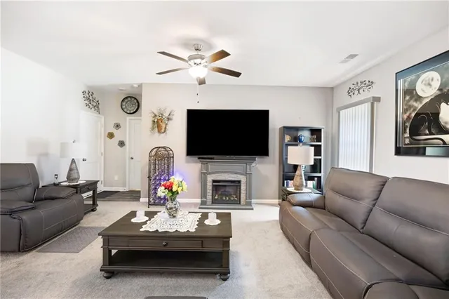a living room with fireplace furniture and a flat screen tv