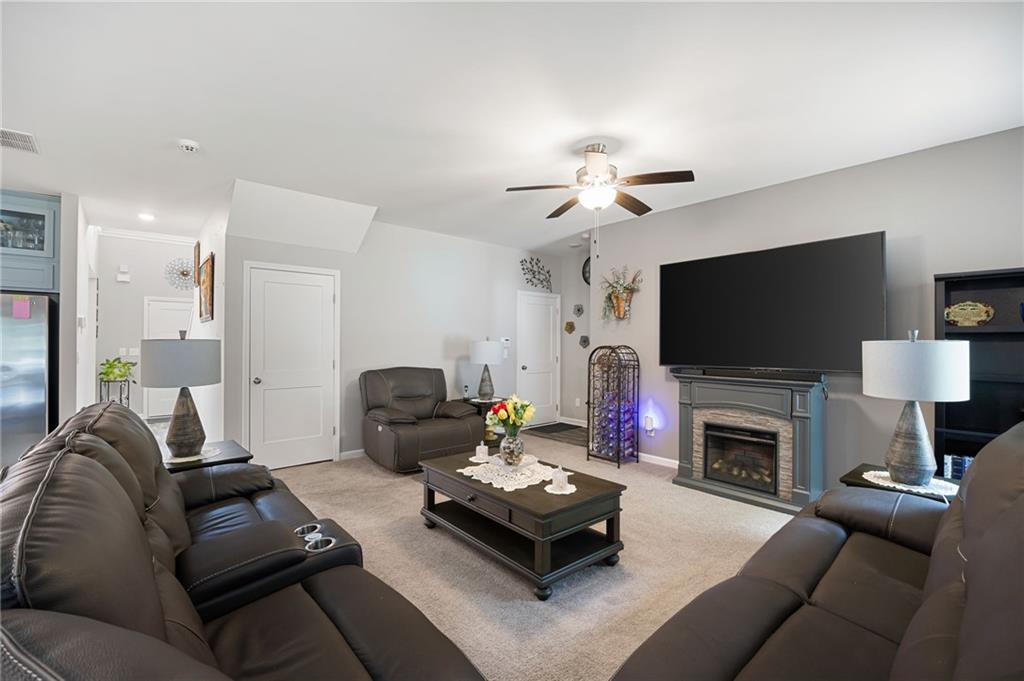406 Splash Pointe Temple, GA 30179 - Photo 7 of 33 a living room with furniture a flat screen tv and a fireplace