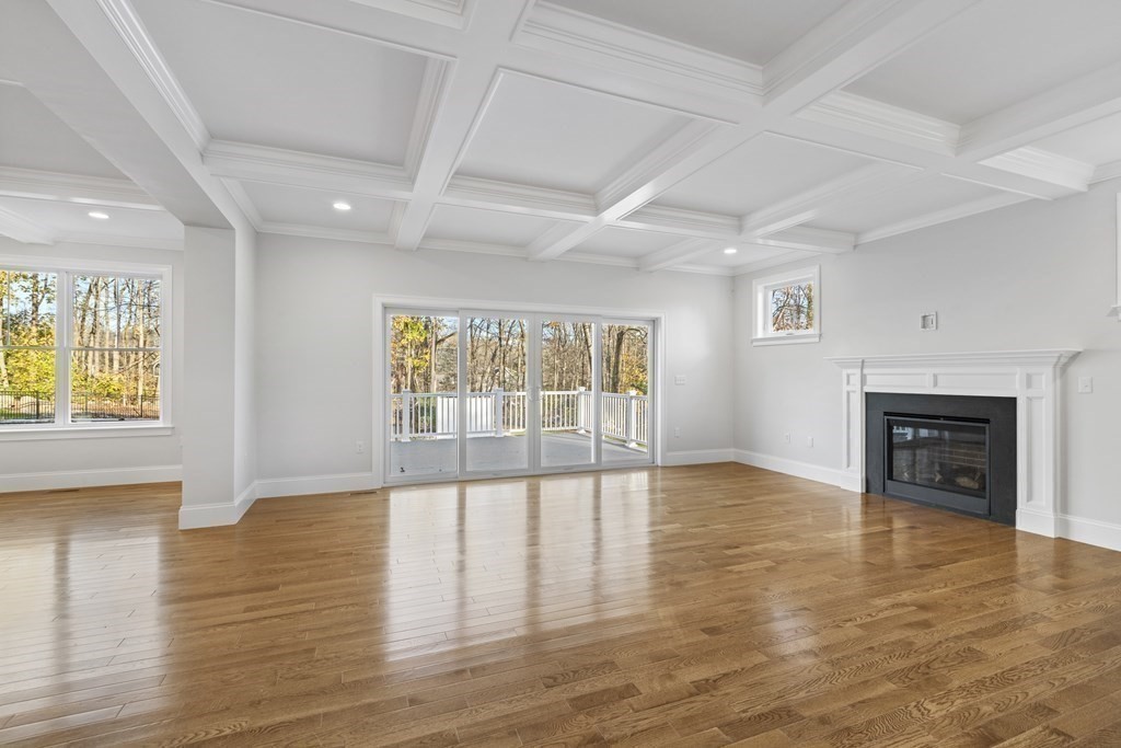 430 High Street Walpole, MA 02081 - Photo 11 of 42 an empty room with wooden floor and fireplace