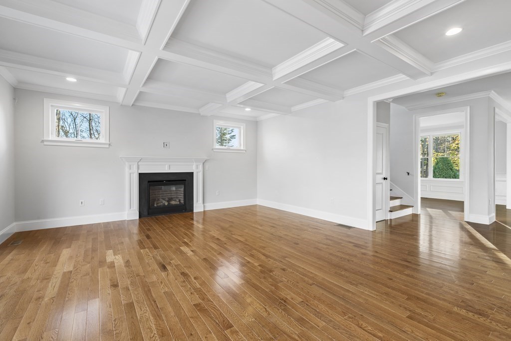 430 High Street Walpole, MA 02081 - Photo 12 of 42 an empty room with wooden floor and fireplace