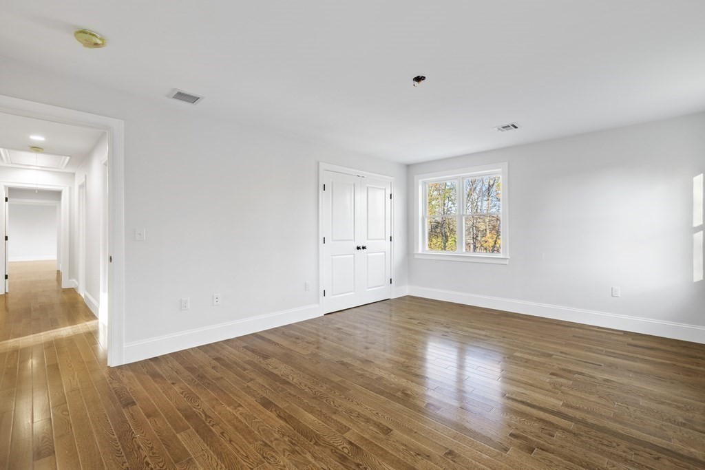 430 High Street Walpole, MA 02081 - Photo 22 of 42 a view of an empty room with wooden floor and a window