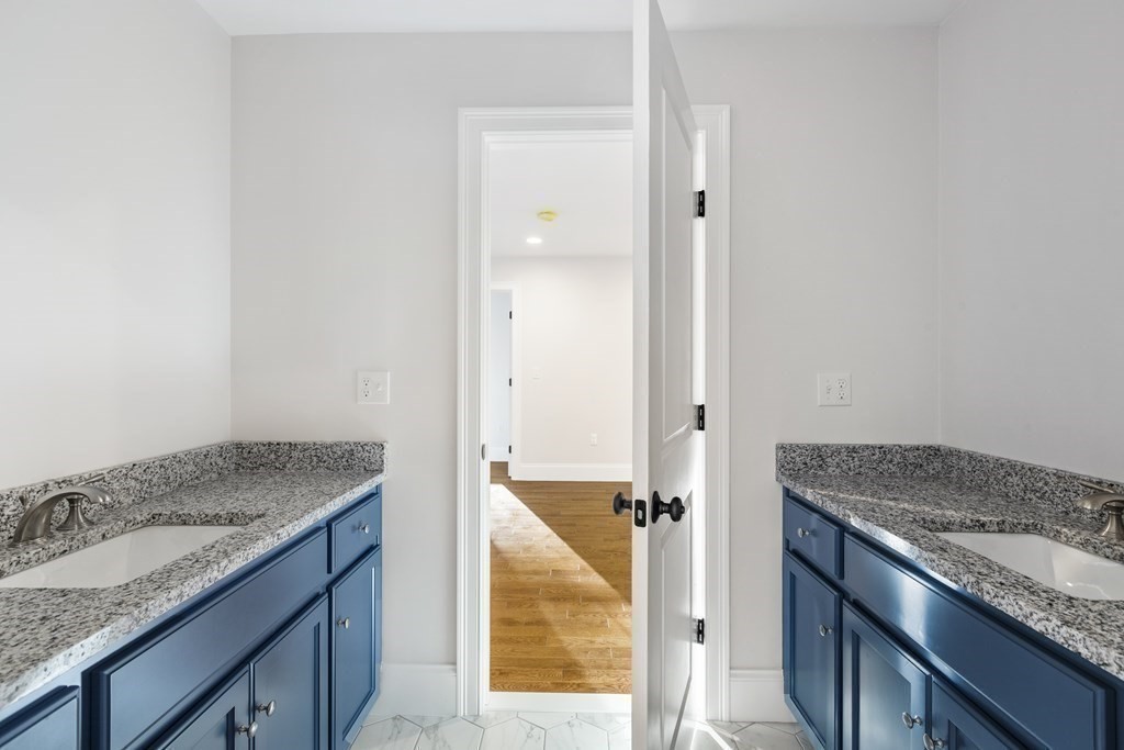 430 High Street Walpole, MA 02081 - Photo 24 of 42 a bathroom with a granite countertop sink and washing machine