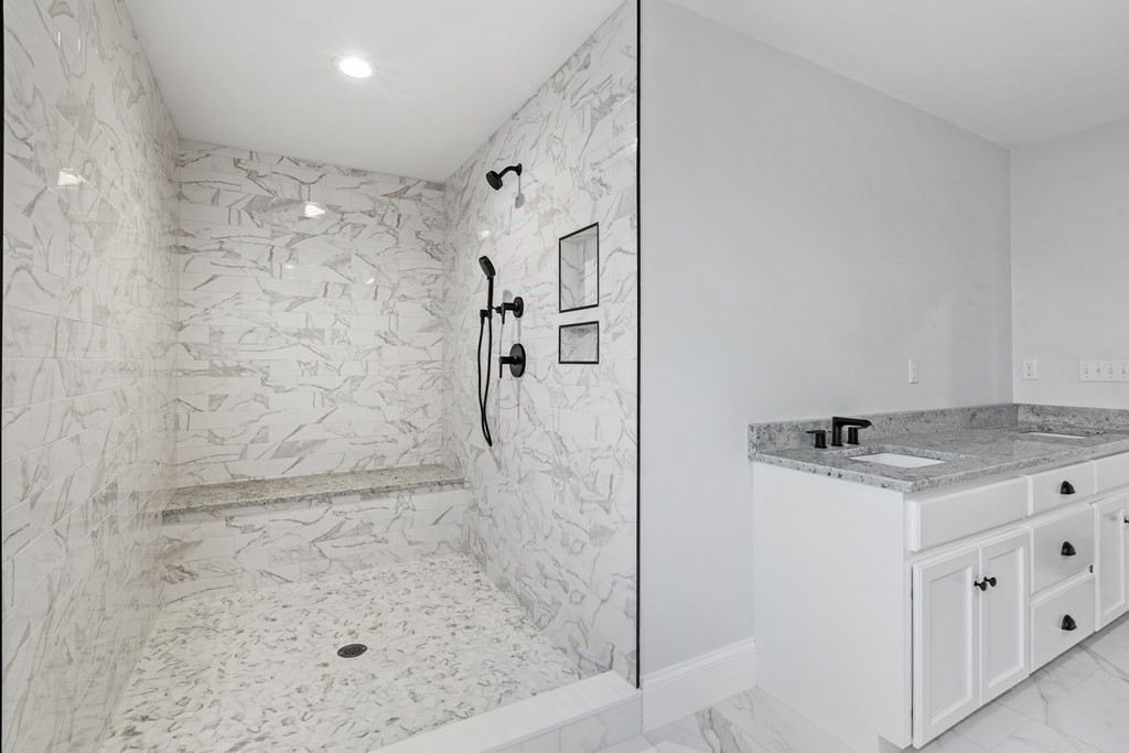 430 High Street Walpole, MA 02081 - Photo 28 of 42 a bathroom with a granite countertop shower sink and mirror