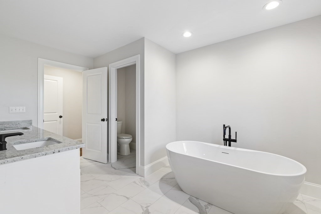 430 High Street Walpole, MA 02081 - Photo 29 of 42 a white bath tub sitting in a bathroom