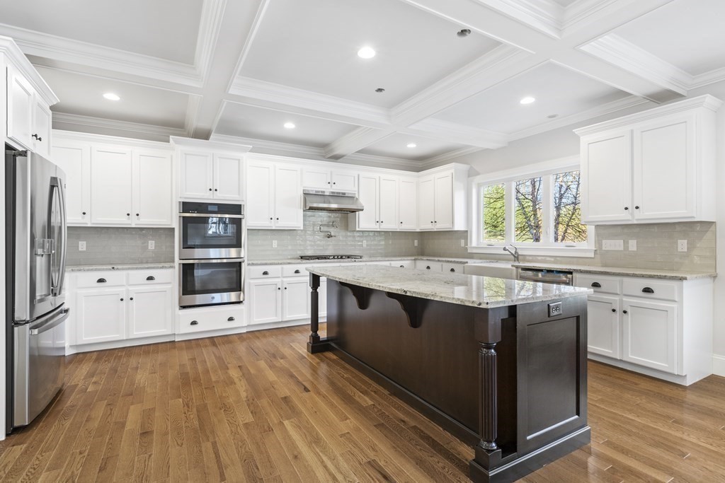 430 High Street Walpole, MA 02081 - Photo 6 of 42 a kitchen with stainless steel appliances granite countertop a refrigerator a stove top oven a sink dishwasher and a refrigerator with wooden floor
