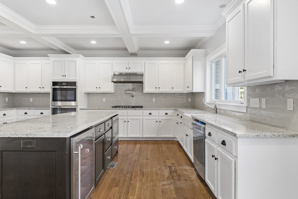 430 High Street Walpole, MA 02081 - Photo 7 of 42 a kitchen with stainless steel appliances granite countertop a sink stove and cabinets