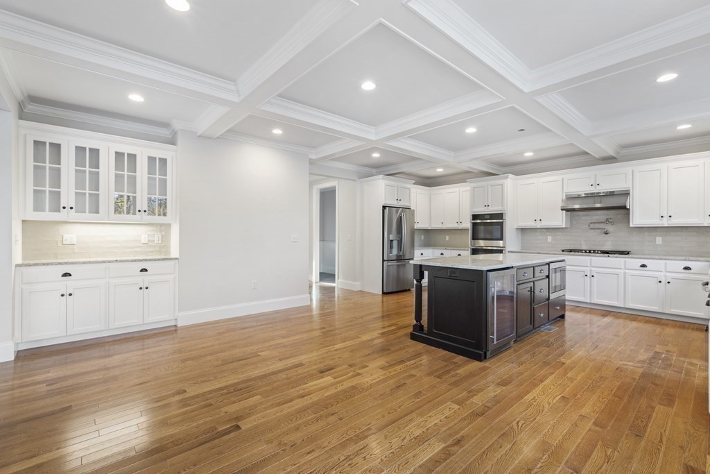 430 High Street Walpole, MA 02081 - Photo 9 of 42 a large kitchen with kitchen island a sink wooden floor and stainless steel appliances