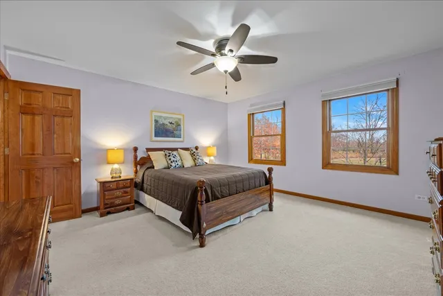 a spacious bedroom with a bed and a chandelier
