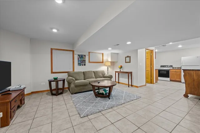 a kitchen with stainless steel appliances granite countertop a refrigerator and a stove