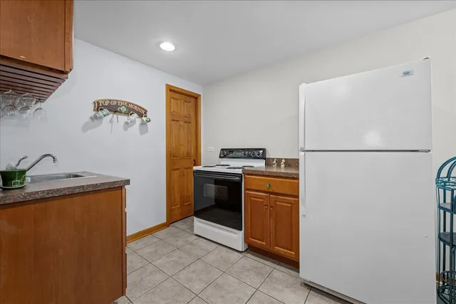 a bathroom with a granite countertop toilet sink and mirror