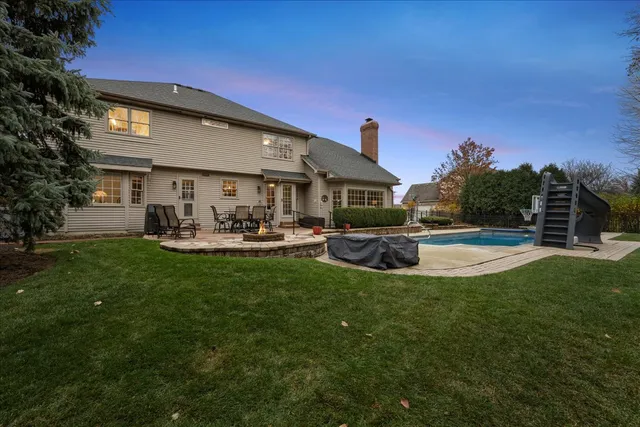 a view of a table and chairs in backyard