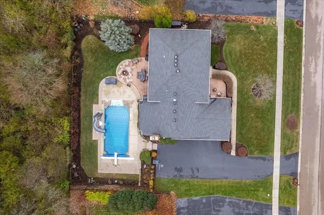 an aerial view of a house with yard swimming pool and outdoor seating