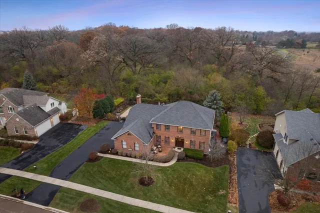 a front view of a house with a garden and yard