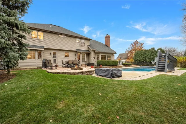 an aerial view of residential houses with outdoor space and swimming pool