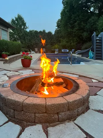 a view of a flower in a garden with a building