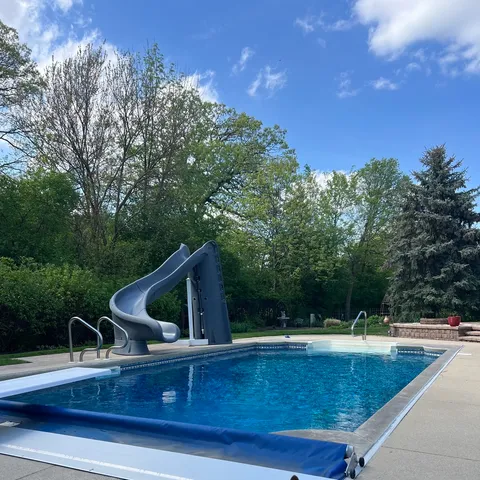 a view of a swimming pool with an outdoor seating