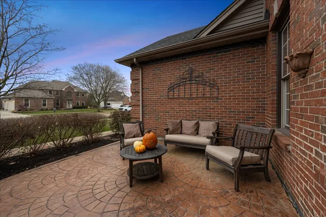 a view of a patio with couple of chairs and a fire pit