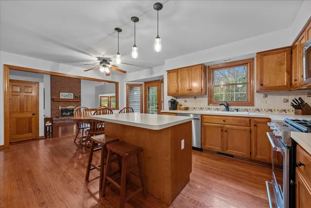 a kitchen with stainless steel appliances granite countertop a sink stove and wooden cabinets