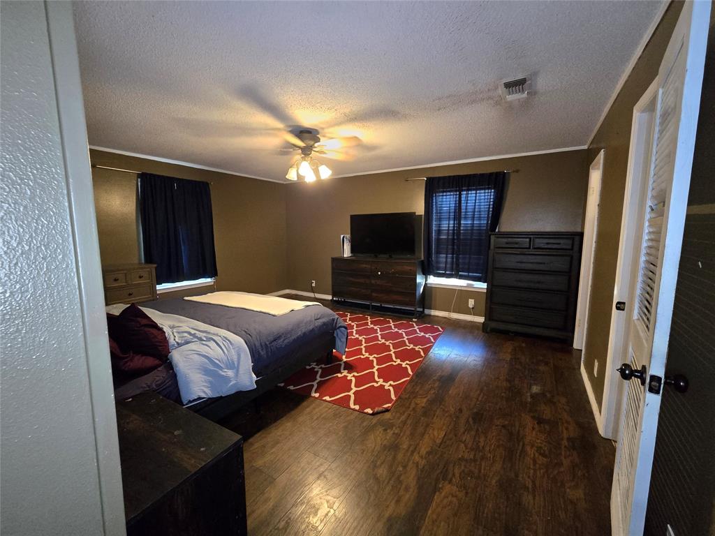 201 Robin Way Mount Vernon, TX 75457 - Photo 18 of 28 a bedroom with a bed and wooden floor