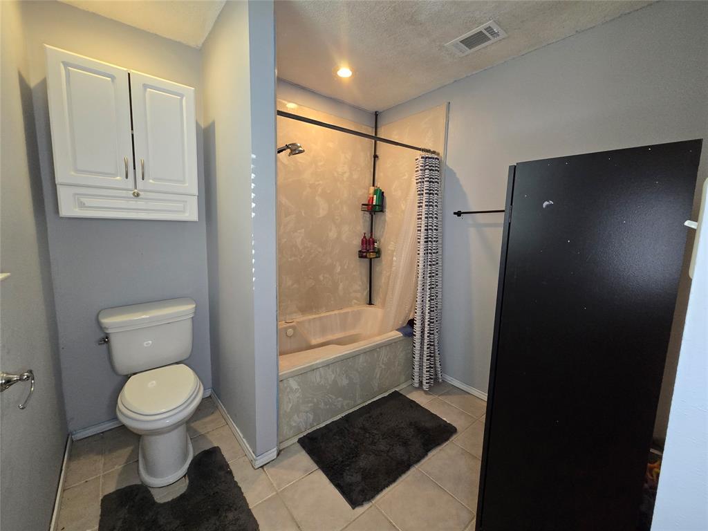 201 Robin Way Mount Vernon, TX 75457 - Photo 21 of 28 a bathroom with a toilet and a shower