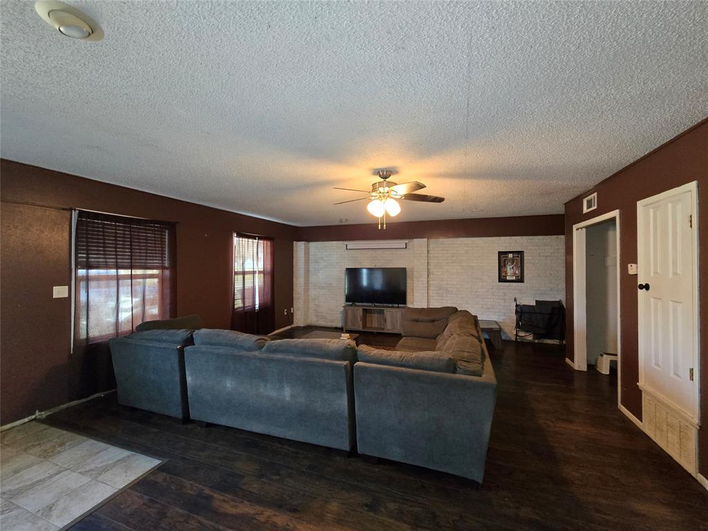201 Robin Way Mount Vernon, TX 75457 - Photo 24 of 28 a living room with furniture and a chandelier