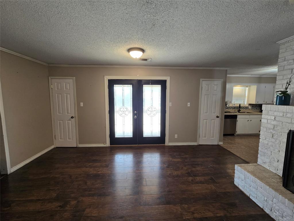201 Robin Way Mount Vernon, TX 75457 - Photo 6 of 28 a view of empty room with wooden floor and kitchen view
