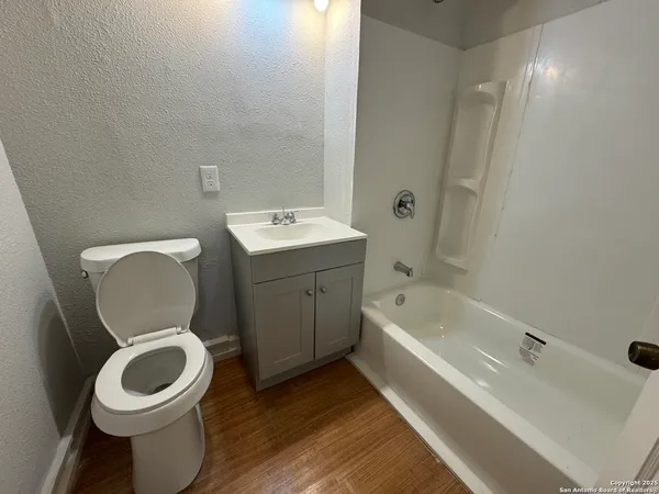a bathroom with a toilet a sink and bathtub