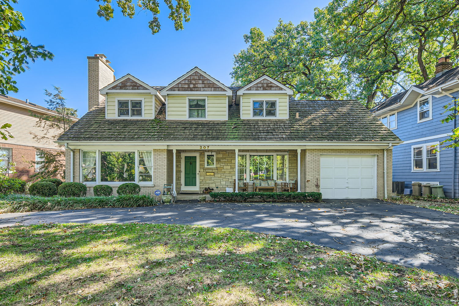 207 Scottswood Road Riverside, IL 60546 - Photo 1 of 32 a front view of a house with a garden