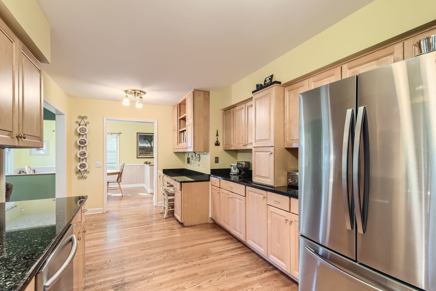 207 Scottswood Road Riverside, IL 60546 - Photo 11 of 32 a kitchen with stainless steel appliances granite countertop a refrigerator a sink and white cabinets
