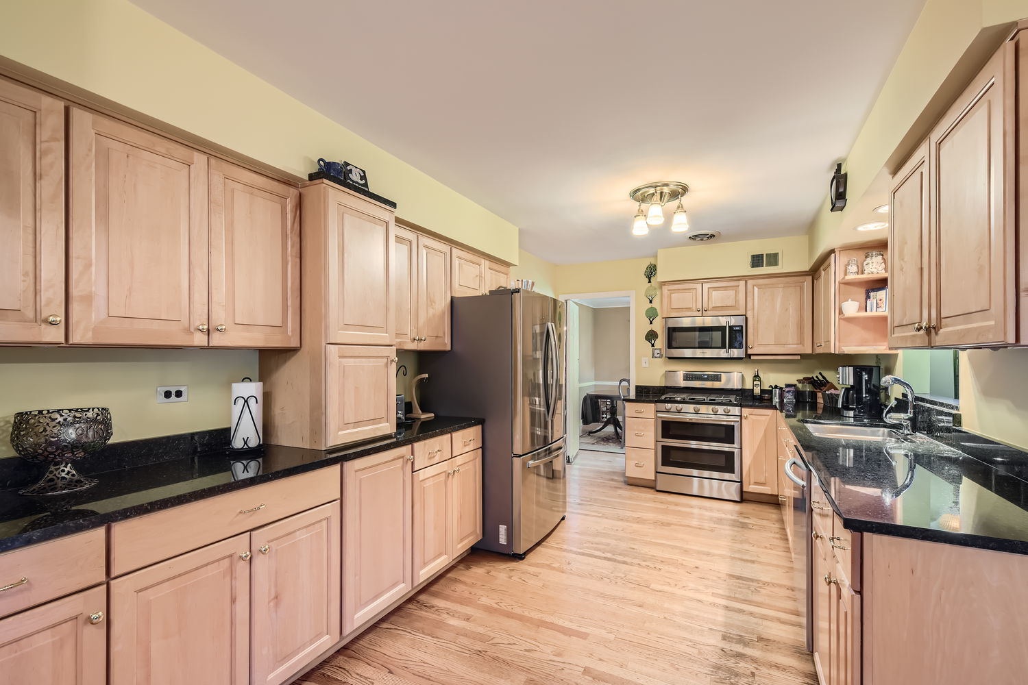 207 Scottswood Road Riverside, IL 60546 - Photo 8 of 32 a kitchen with stainless steel appliances a sink cabinets and wooden floor