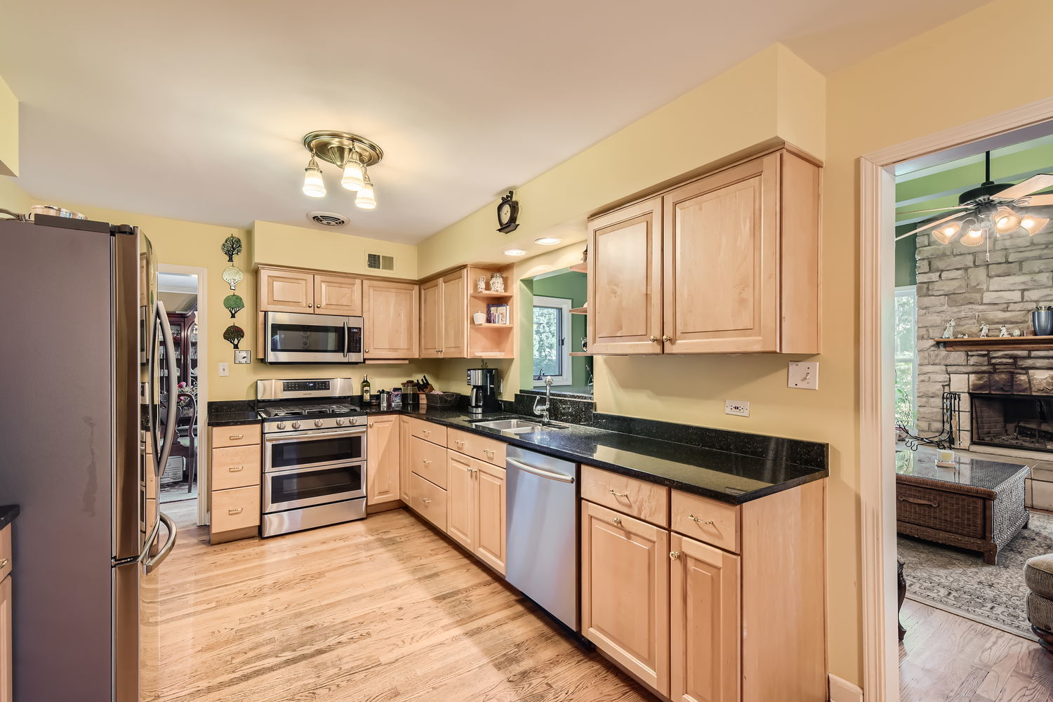 207 Scottswood Road Riverside, IL 60546 - Photo 9 of 32 a kitchen with stainless steel appliances granite countertop a stove top oven a refrigerator a sink and dishwasher with white cabinets