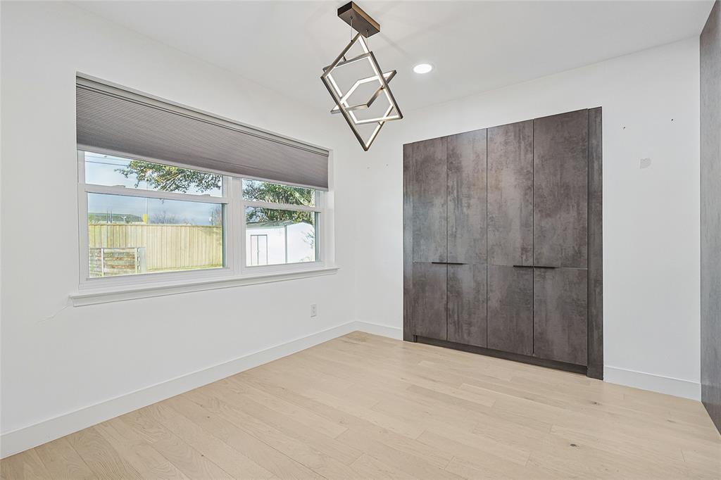 12417 Quincy Lane Dallas, TX 75230 - Photo 12 of 40 a view of empty room with window and chandelier