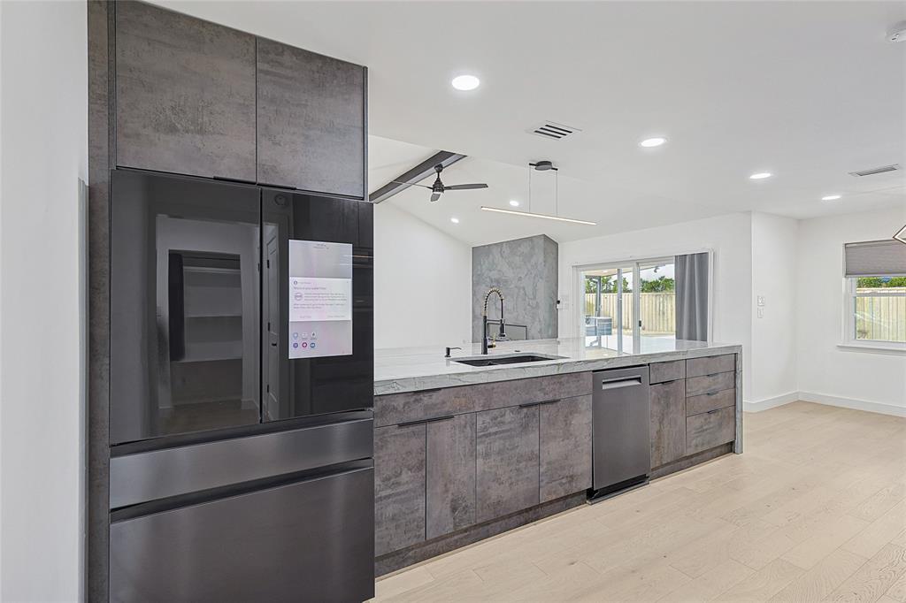 12417 Quincy Lane Dallas, TX 75230 - Photo 17 of 40 a large kitchen with stainless steel appliances granite countertop a refrigerator and a sink