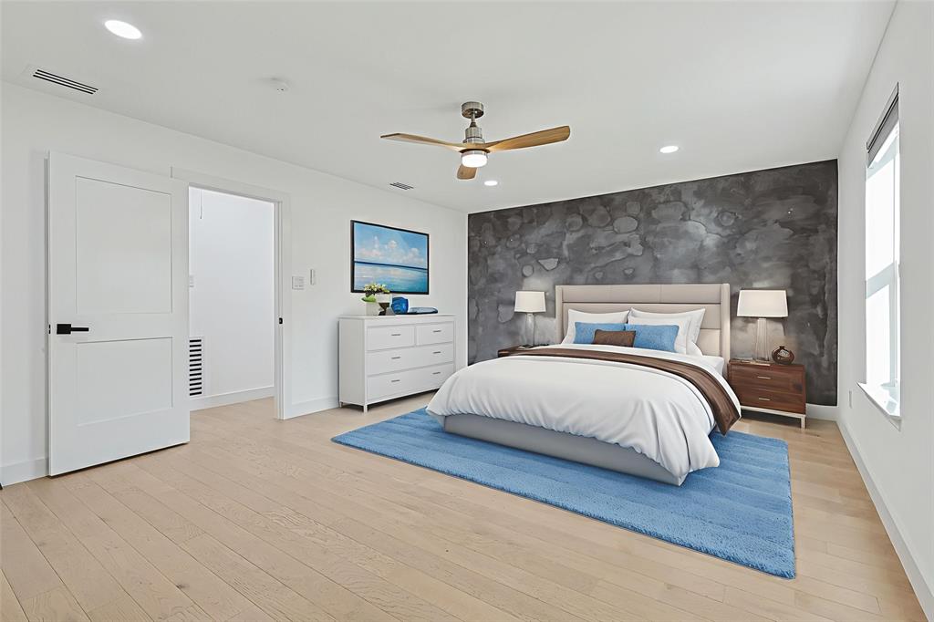 12417 Quincy Lane Dallas, TX 75230 - Photo 19 of 40 a bedroom with a large bed and ceiling fan