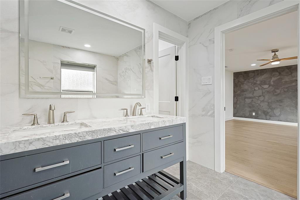 12417 Quincy Lane Dallas, TX 75230 - Photo 23 of 40 a bathroom with a granite countertop sink mirror and double