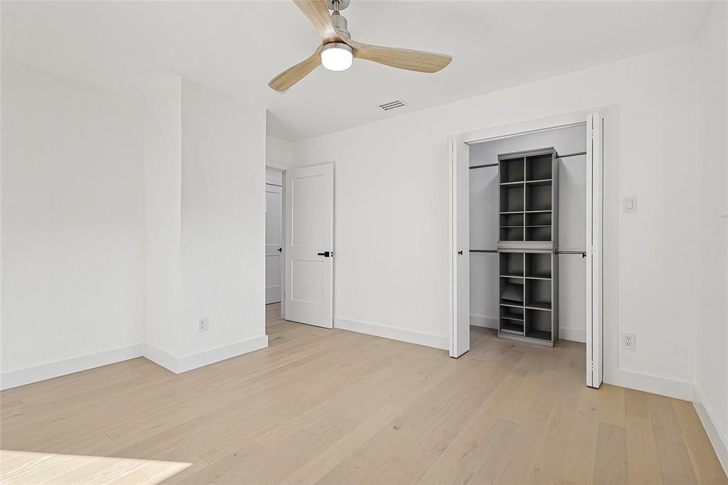 12417 Quincy Lane Dallas, TX 75230 - Photo 29 of 40 an empty room with a empty space and chandelier fan