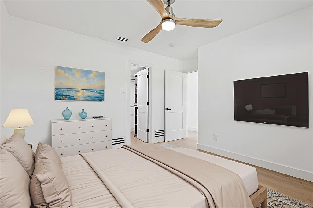 12417 Quincy Lane Dallas, TX 75230 - Photo 30 of 40 a bedroom with a bed and a flat screen tv