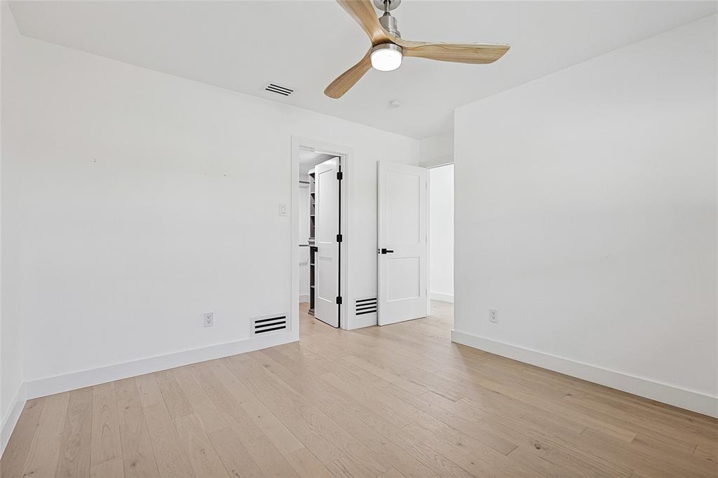 12417 Quincy Lane Dallas, TX 75230 - Photo 31 of 40 an empty room with a empty space and a ceiling fan